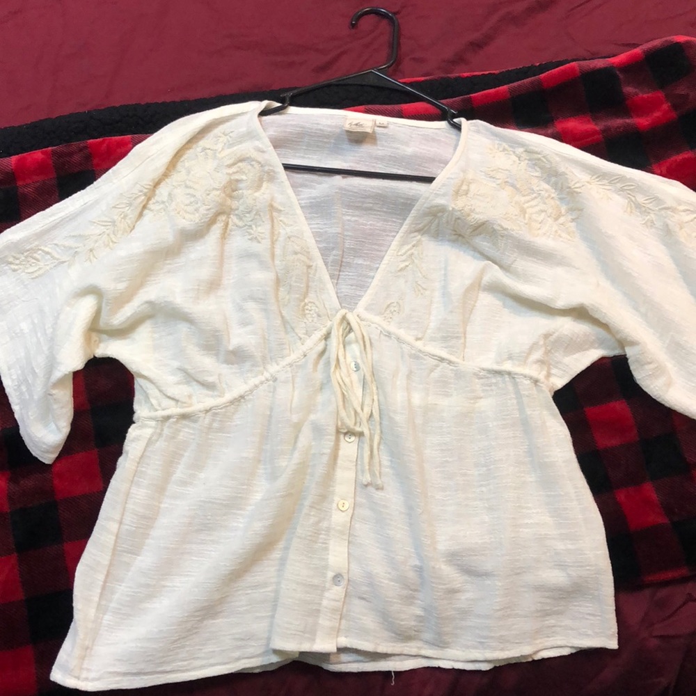 Woman’s cream colored bohemian top